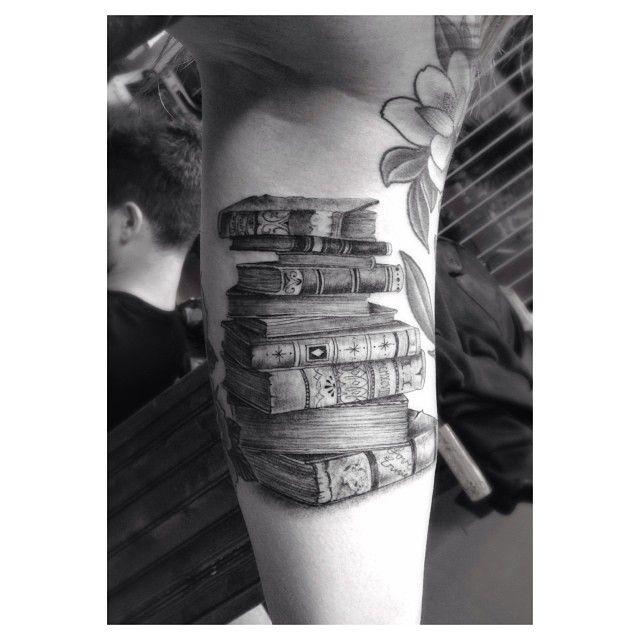 Adorable black book tattoo on arm - Book Tattoos